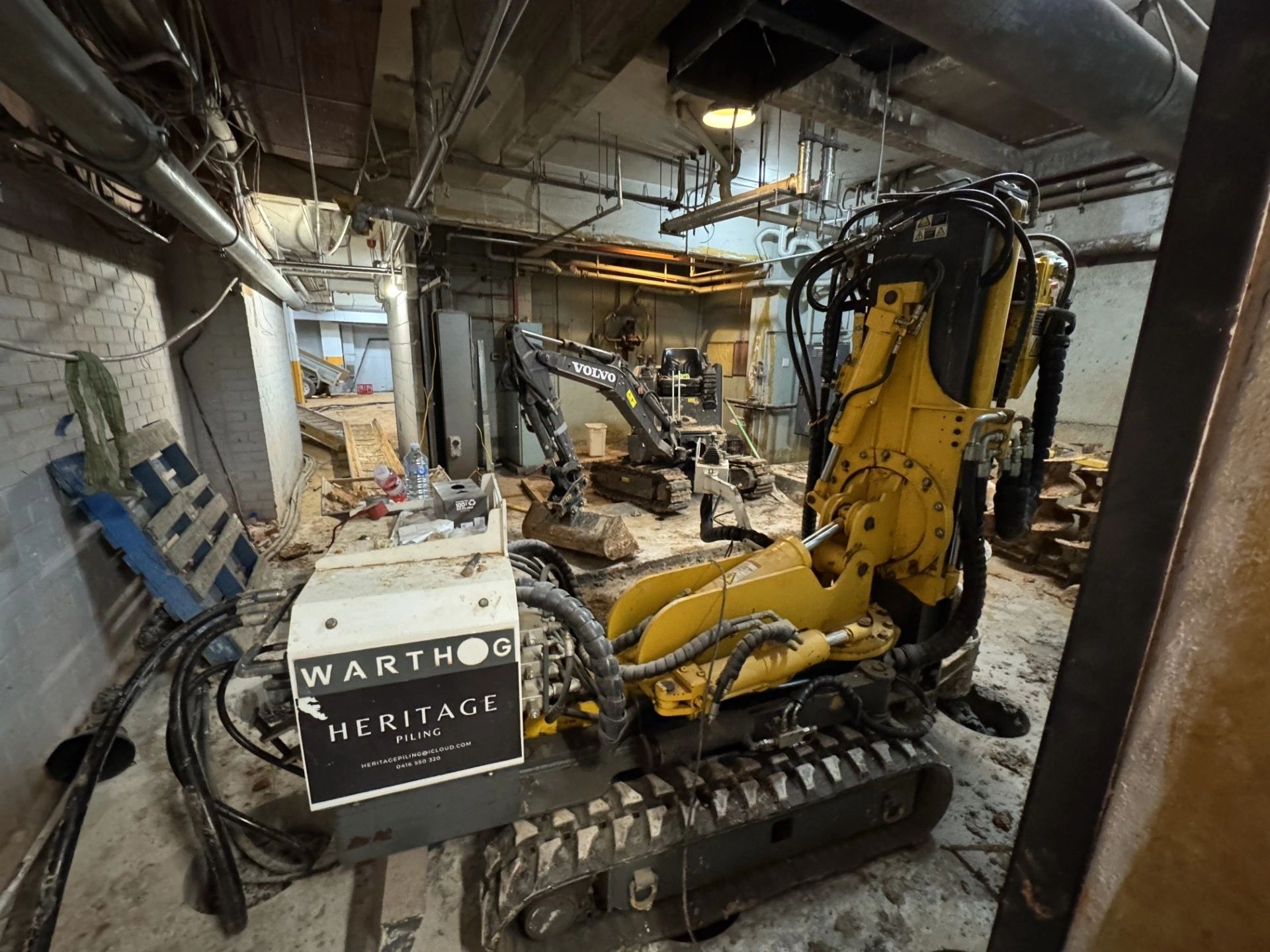 Compact drilling rig working beneath a low ceiling inside an existing building